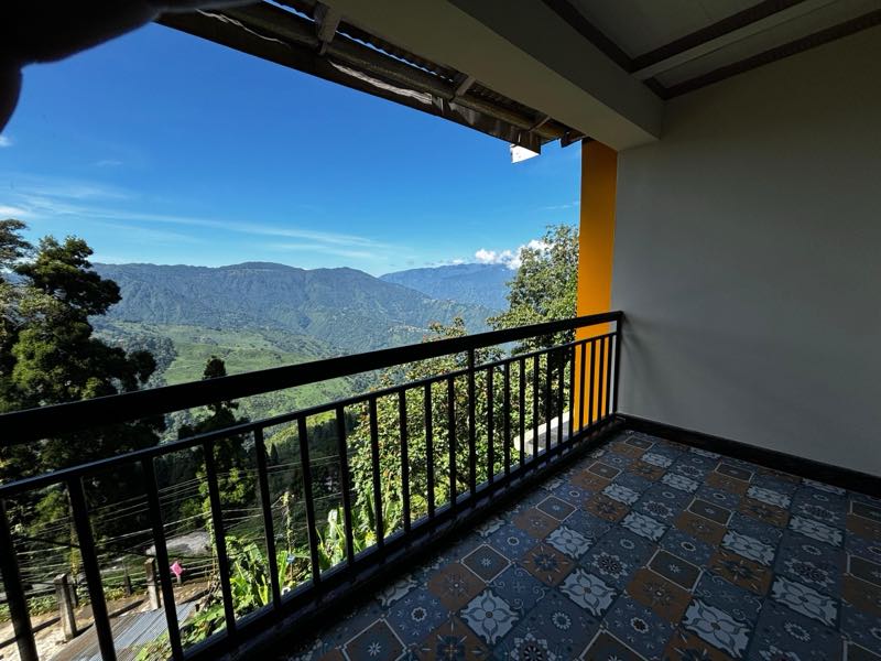 The view from an Asraya balcony across the valley to the tea gardens and forested ridges beyond