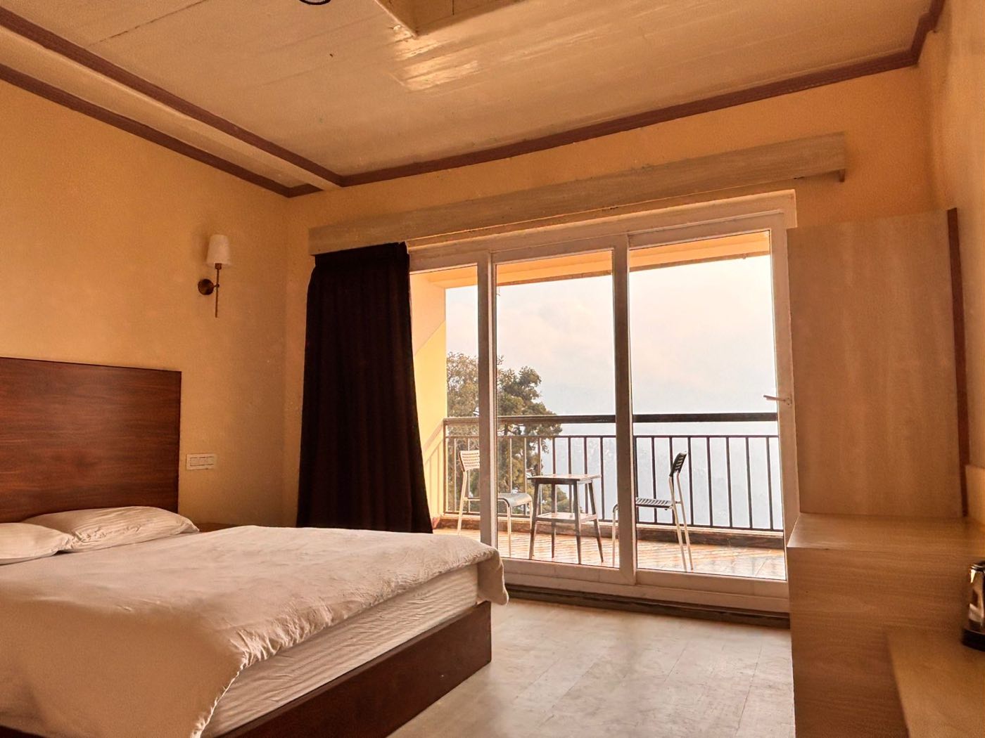 The Anna Kashfi room: late afternoon light flooding through sliding doors onto the bed